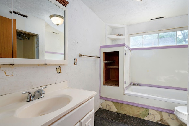 427 Morgan Ave, Aurora, MO 65605 - bathroom with a textured ceiling, vanity, and a bath
