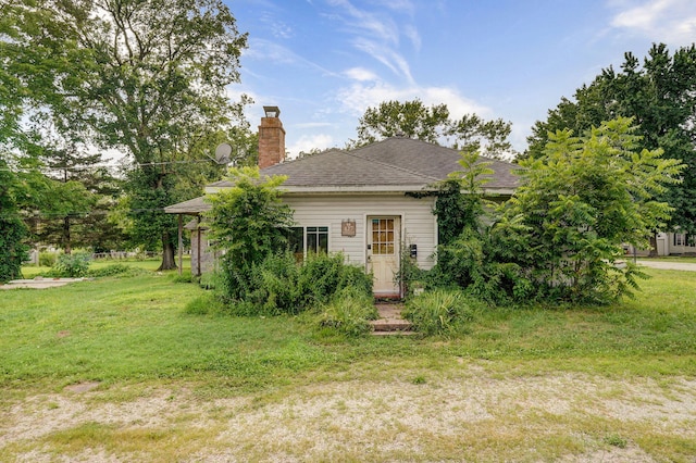 427 Morgan Ave, Aurora, MO 65605 - back of property with a chimney, a lawn, and roof with shingles
