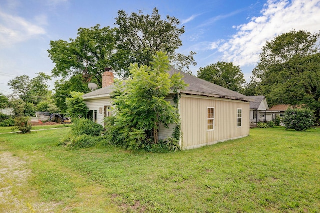 427 Morgan Ave, Aurora, MO 65605 - view of side of home with a lawn and a chimney