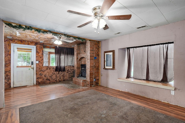 427 Morgan Ave, Aurora, MO 65605 - unfurnished living room featuring wood finished floors, ceiling fan, and a fireplace