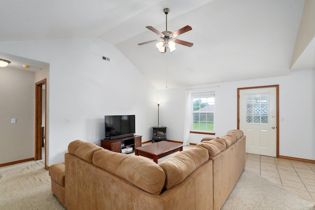 218 Tyler Ct, Mount Vernon, MO 65712 - living room with a ceiling fan, light colored carpet, high vaulted ceiling, light tile patterned flooring, and a wood stove