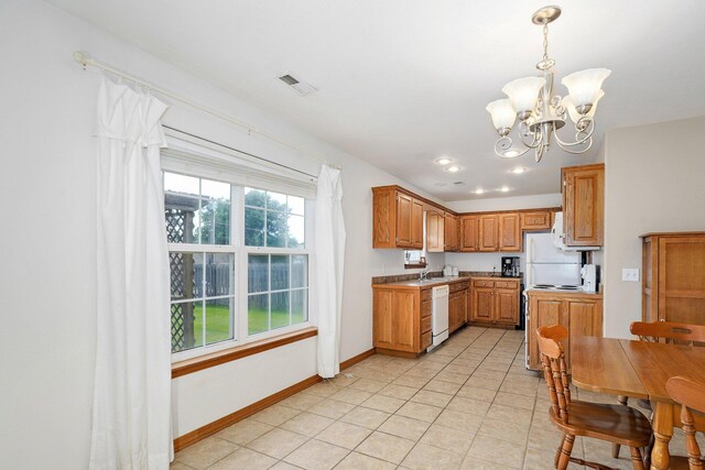 218 Tyler Ct, Mount Vernon, MO 65712 - kitchen with white appliances, a chandelier, light tile patterned flooring, hanging light fixtures, and brown cabinets