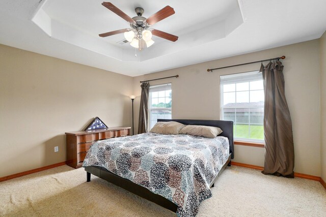 218 Tyler Ct, Mount Vernon, MO 65712 - carpeted bedroom with a tray ceiling and a ceiling fan