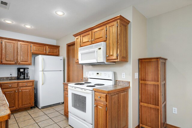 218 Tyler Ct, Mount Vernon, MO 65712 - kitchen with white appliances, brown cabinetry, recessed lighting, and light tile patterned flooring