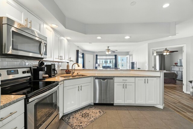 215 Meadow Brook Ln Unit 3, Branson, MO 65616 - kitchen featuring stainless steel appliances, ceiling fan, white cabinetry, recessed lighting, and a peninsula