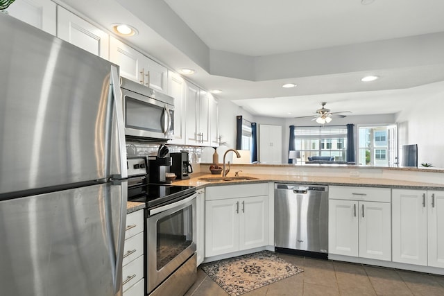 215 Meadow Brook Ln Unit 3, Branson, MO 65616 - kitchen with stainless steel appliances, recessed lighting, white cabinets, tile patterned flooring, and light stone counters