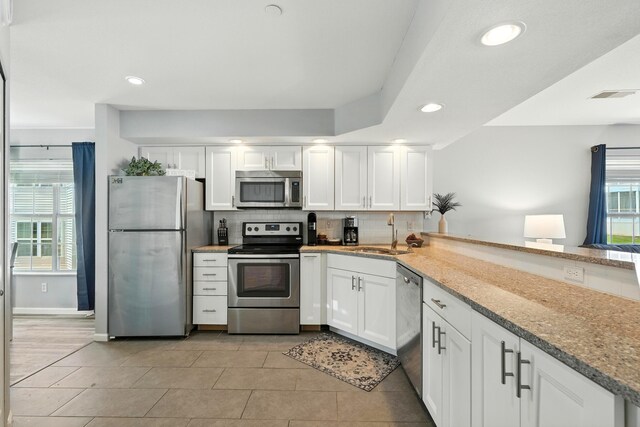 215 Meadow Brook Ln Unit 3, Branson, MO 65616 - kitchen featuring stainless steel appliances, white cabinetry, recessed lighting, decorative backsplash, and stone countertops