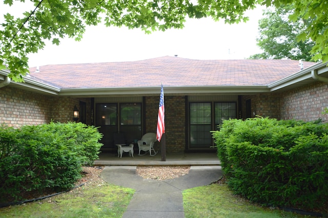 1761-1763 E Lark St, Springfield, MO 65804 - entrance to property featuring covered porch, brick siding, and roof with shingles