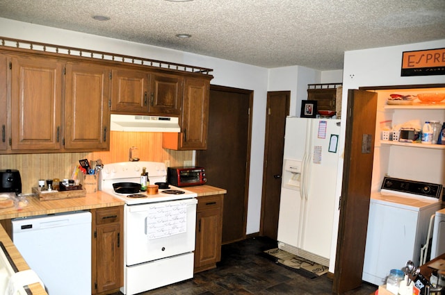 1761-1763 E Lark St, Springfield, MO 65804 - kitchen with white appliances, under cabinet range hood, washer / dryer, light countertops, and a textured ceiling