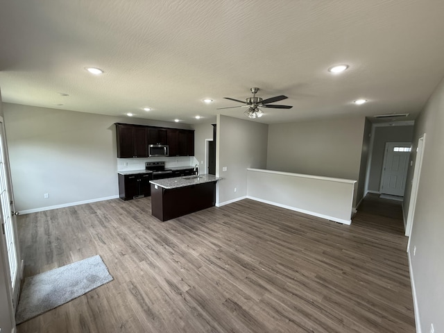 401 E Wright St, Willard, MO 65781 - kitchen featuring open floor plan, stainless steel microwave, wood finished floors, ceiling fan, and recessed lighting