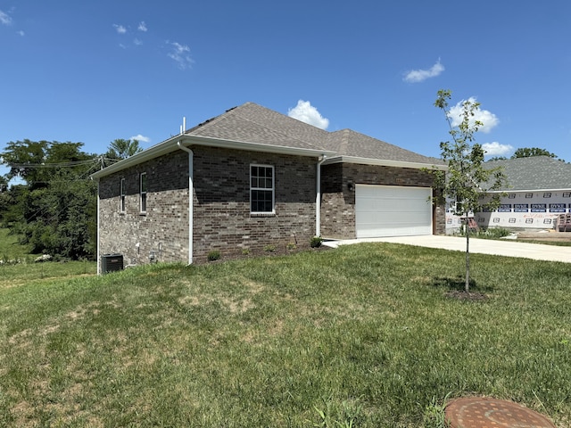 401 E Wright St, Willard, MO 65781 - view of side of property featuring an attached garage, driveway, a lawn, brick siding, and roof with shingles