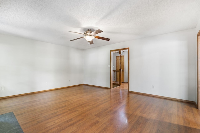 1801 W Cherokee St, Springfield, MO 65807 - empty room featuring a ceiling fan, wood finished floors, and a textured ceiling