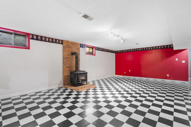 1801 W Cherokee St, Springfield, MO 65807 - finished below grade area featuring a wood stove and a textured ceiling