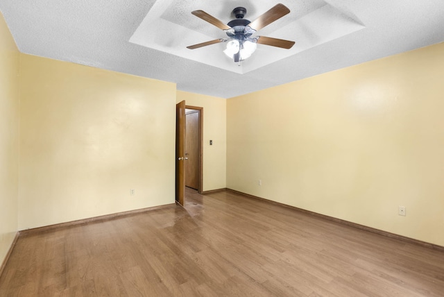 1801 W Cherokee St, Springfield, MO 65807 - empty room featuring light wood-style floors, a tray ceiling, and ceiling fan