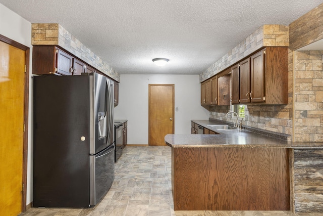 1801 W Cherokee St, Springfield, MO 65807 - kitchen with stainless steel fridge with ice dispenser, a peninsula, a textured ceiling, black electric range, and backsplash