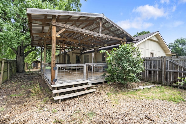 1801 W Cherokee St, Springfield, MO 65807 - fenced backyard featuring a wooden deck, a ceiling fan, and a storage shed