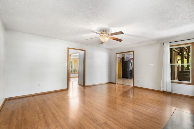 1801 W Cherokee St, Springfield, MO 65807 - empty room featuring light wood-type flooring, ceiling fan, and a textured ceiling