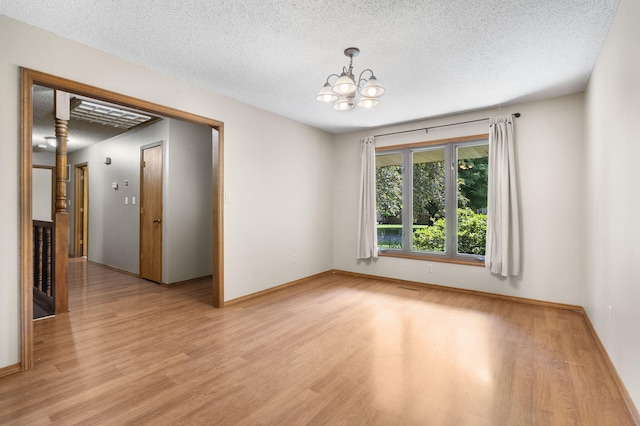1801 W Cherokee St, Springfield, MO 65807 - spare room with light wood-style floors, a textured ceiling, and a chandelier