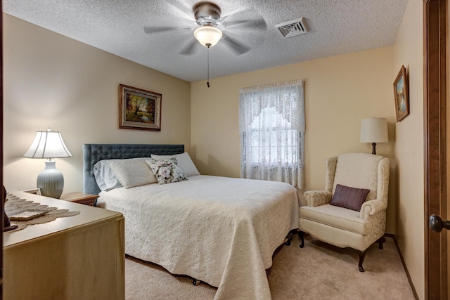 1706 Ankney Pl, Neosho, MO 64850 - bedroom featuring light colored carpet, a textured ceiling, and a ceiling fan