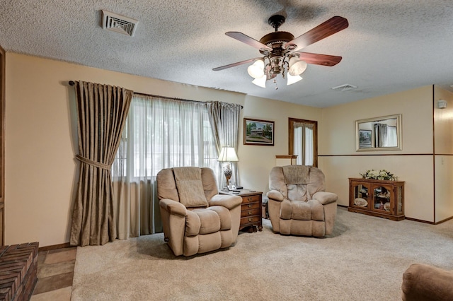 1706 Ankney Pl, Neosho, MO 64850 - carpeted living room featuring ceiling fan and a textured ceiling