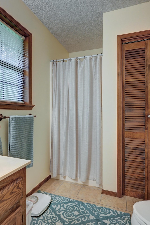 1706 Ankney Pl, Neosho, MO 64850 - full bath featuring vanity, a textured ceiling, tile patterned flooring, and a shower with curtain