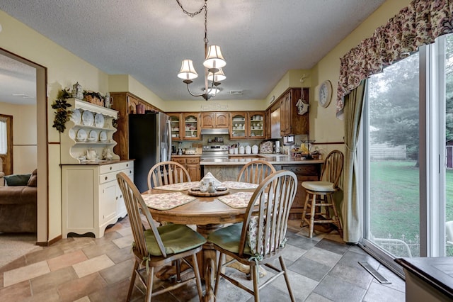 1706 Ankney Pl, Neosho, MO 64850 - dining area with a textured ceiling, plenty of natural light, and a chandelier