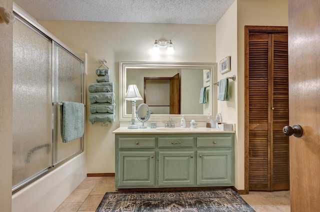 1706 Ankney Pl, Neosho, MO 64850 - bathroom with tile patterned floors, a closet, vanity, bath / shower combo with glass door, and a textured ceiling