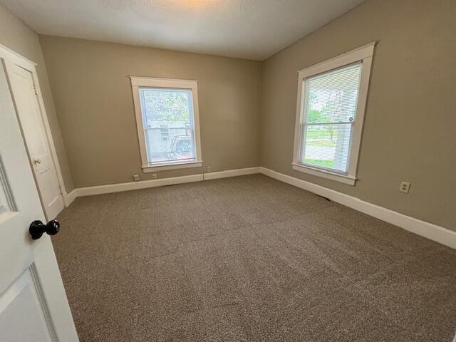 1322 W Atlantic St, Springfield, MO 65803 - carpeted empty room featuring baseboards