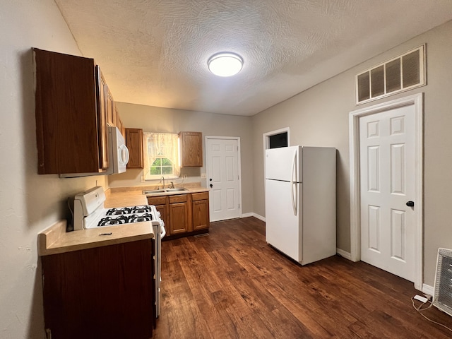1322 W Atlantic St, Springfield, MO 65803 - kitchen with white appliances, light countertops, dark wood-style flooring, brown cabinets, and a textured ceiling