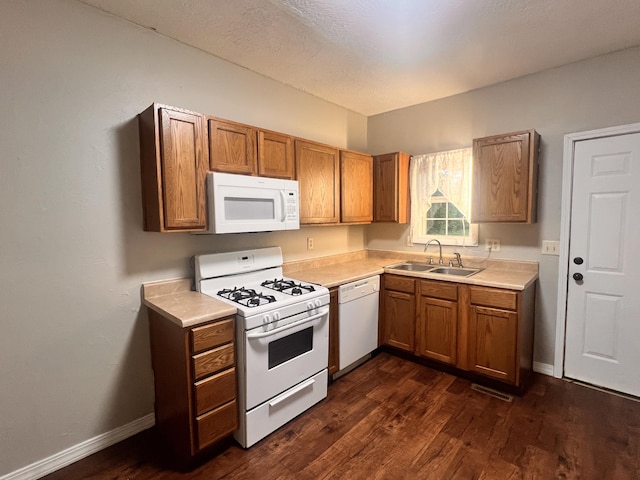 1322 W Atlantic St, Springfield, MO 65803 - kitchen featuring white appliances, brown cabinetry, dark wood finished floors, and light countertops