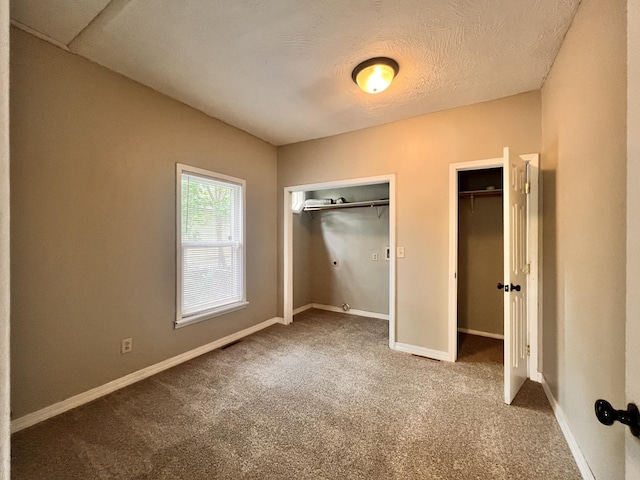 1322 W Atlantic St, Springfield, MO 65803 - unfurnished bedroom featuring carpet flooring, two closets, and a textured ceiling