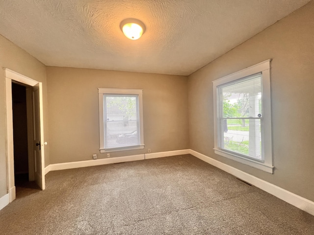 1322 W Atlantic St, Springfield, MO 65803 - carpeted spare room with a textured ceiling and baseboards