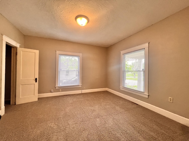 1322 W Atlantic St, Springfield, MO 65803 - carpeted spare room with baseboards and a textured ceiling