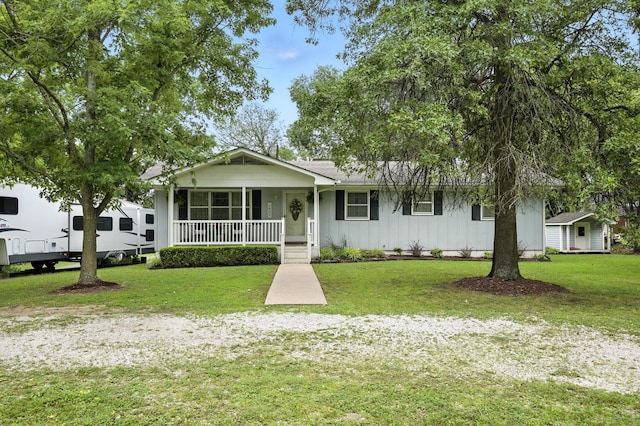 601 Linzee Blvd, Pierce City, MO 65723 - view of front of house with board and batten siding, a porch, a front lawn, and a shed