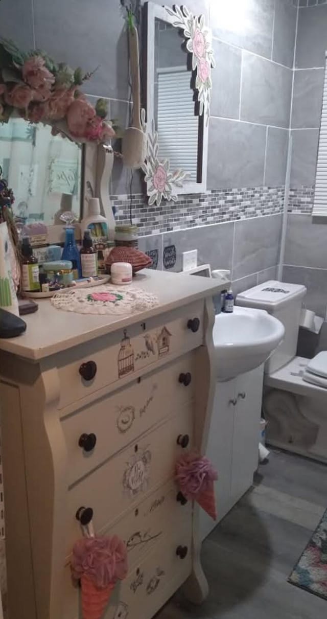 231 W School St, Everton, MO 65646 - bathroom with vanity, tasteful backsplash, and tile walls
