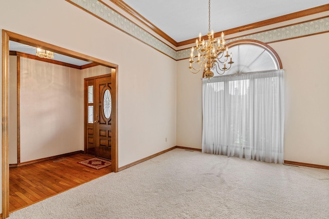 4081 E Kingsbury St, Springfield, MO 65809 - unfurnished room featuring a chandelier, ornamental molding, carpet floors, and wood finished floors