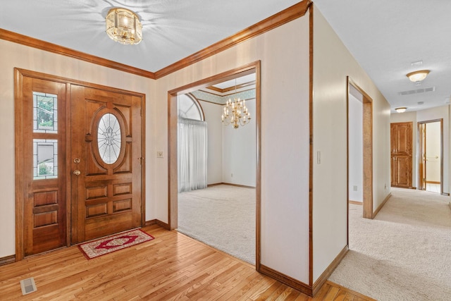 4081 E Kingsbury St, Springfield, MO 65809 - entryway with a chandelier, light wood finished floors, crown molding, and light colored carpet