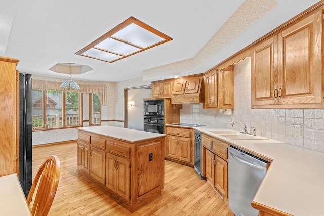 4081 E Kingsbury St, Springfield, MO 65809 - kitchen featuring black appliances, wallpapered walls, light wood finished floors, light countertops, and a kitchen island