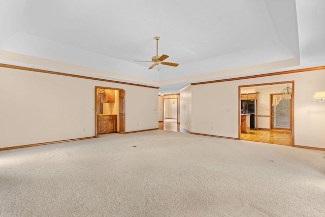 4081 E Kingsbury St, Springfield, MO 65809 - empty room featuring light carpet, a ceiling fan, and a tray ceiling
