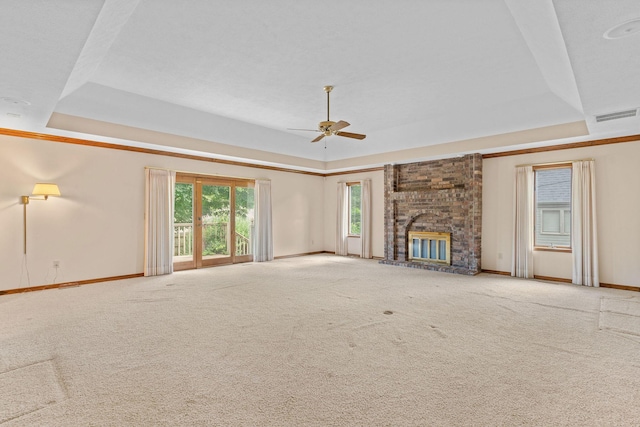 4081 E Kingsbury St, Springfield, MO 65809 - unfurnished living room featuring a raised ceiling, carpet, a ceiling fan, and a fireplace