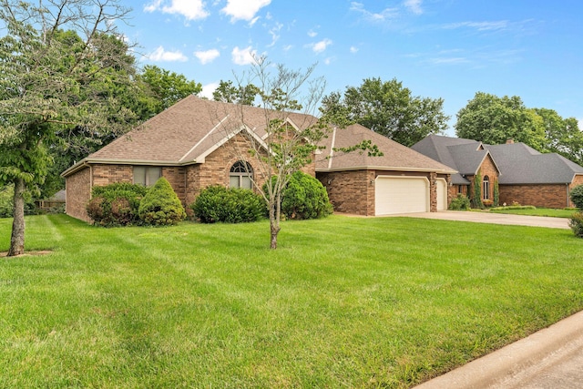 4081 E Kingsbury St, Springfield, MO 65809 - view of front of home featuring brick siding, an attached garage, driveway, and a front lawn