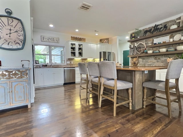 556 Carter 309, Van Buren, MO 63965 - kitchen featuring open shelves, appliances with stainless steel finishes, white cabinetry, crown molding, and decorative backsplash