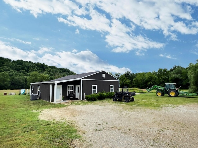 556 Carter 309, Van Buren, MO 63965 - view of side of property featuring a forest view, a lawn, and an outbuilding