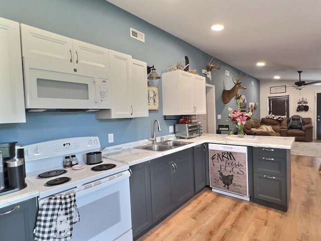 556 Carter 309, Van Buren, MO 63965 - kitchen with white appliances, a peninsula, light countertops, a ceiling fan, and light wood-style floors