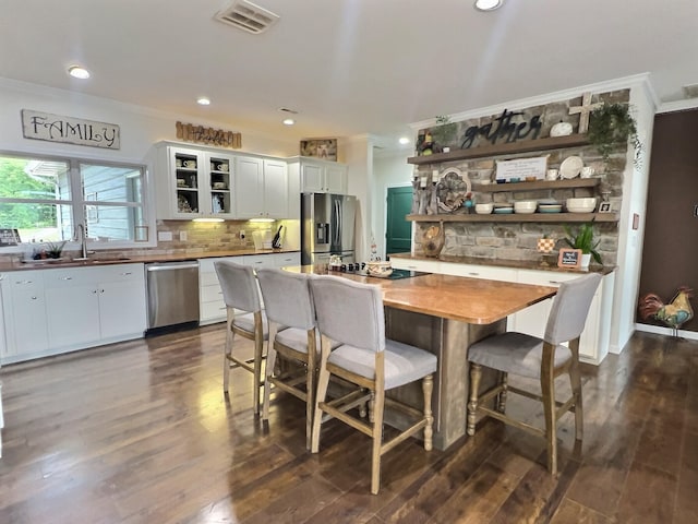 556 Carter 309, Van Buren, MO 63965 - kitchen featuring appliances with stainless steel finishes, open shelves, crown molding, white cabinets, and tasteful backsplash