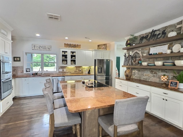 556 Carter 309, Van Buren, MO 63965 - kitchen with appliances with stainless steel finishes, open shelves, ornamental molding, white cabinetry, and tasteful backsplash