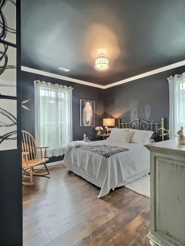556 Carter 309, Van Buren, MO 63965 - bedroom with multiple windows, ornamental molding, and dark wood finished floors