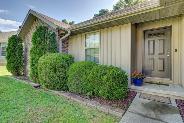 5834 Geranium Ln, Battlefield, MO 65619 - view of exterior entry with a shingled roof and a lawn