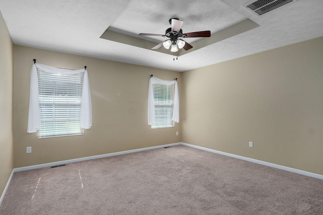 5834 Geranium Ln, Battlefield, MO 65619 - spare room featuring carpet floors, a ceiling fan, a textured ceiling, and a raised ceiling