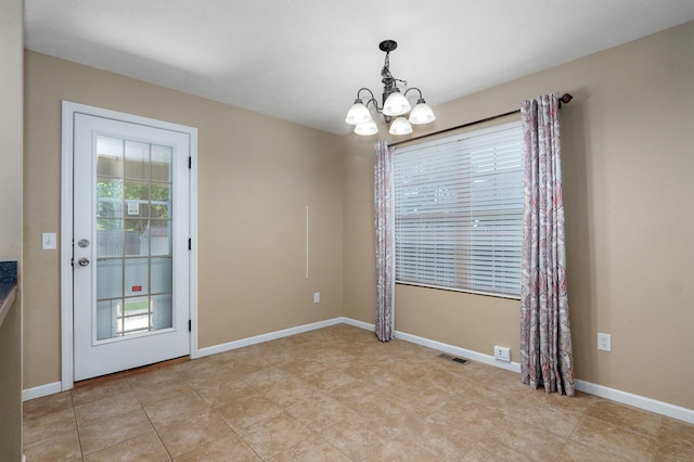 5834 Geranium Ln, Battlefield, MO 65619 - unfurnished dining area with a chandelier and light tile patterned flooring